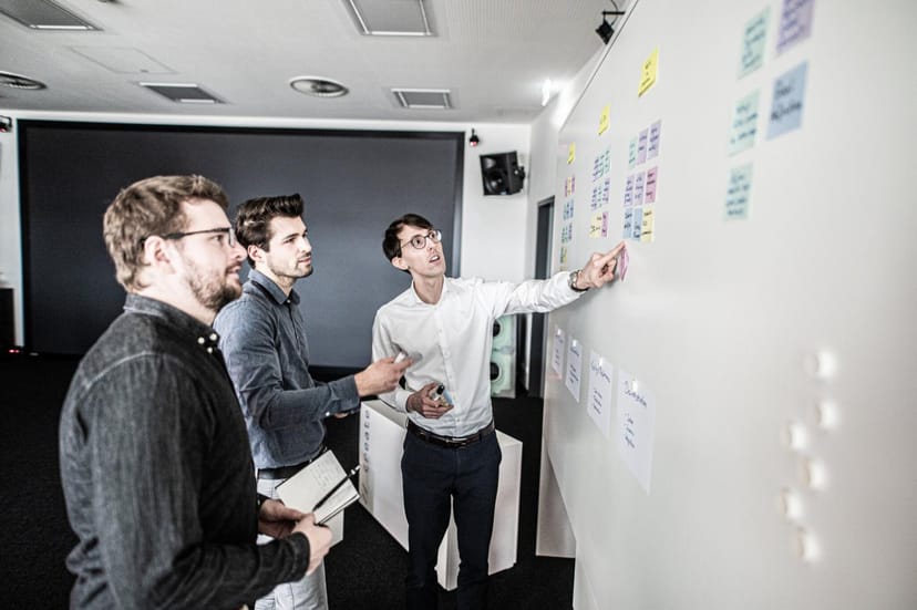 Collaborative brainstorming session in Innovation Accelerator with colorful sticky notes.