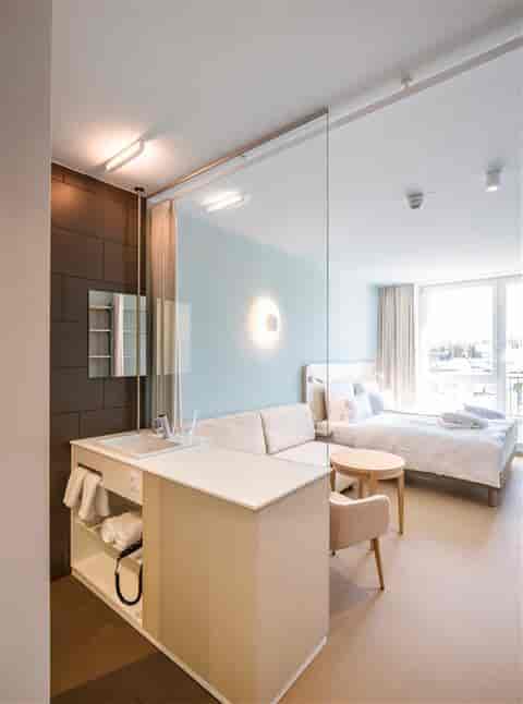 Modern hotel room with glass divider, ideal for meetings and retreats at A-ROSA Travemünde.