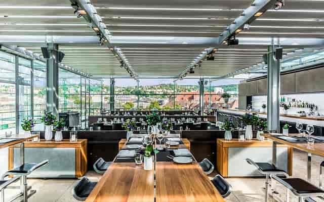 Modern event space at CUBE Restaurant with large windows for corporate and private gatherings.