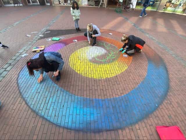 Vibrant outdoor chalk art mural installation at art gallery event in The Village.
