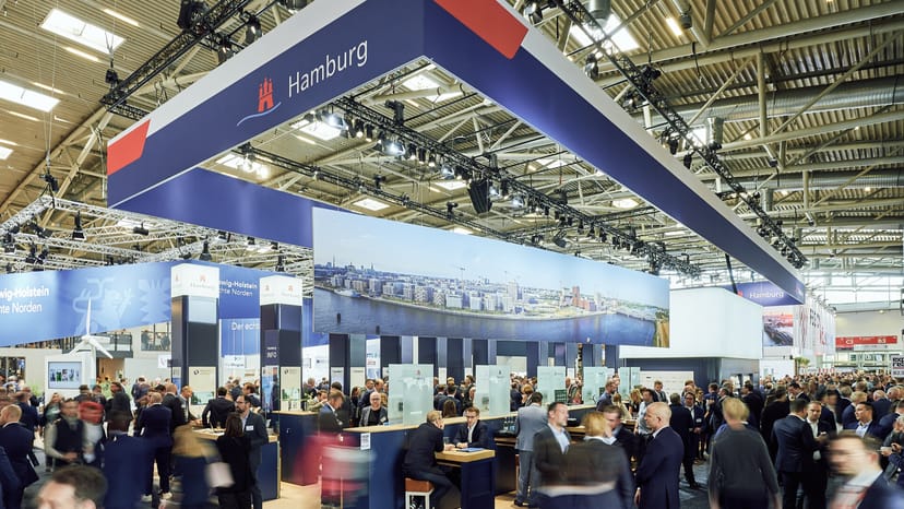 "Busy trade show at Expo Hall featuring Hamburg-themed exhibit and networking opportunities."
