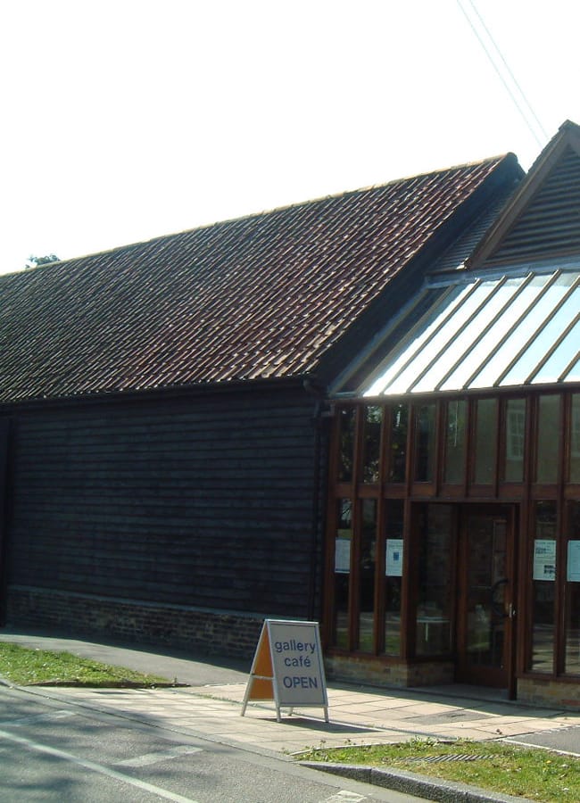 Art center at Riverhouse Barn, rustic wooden exterior with glass panels, event venue.