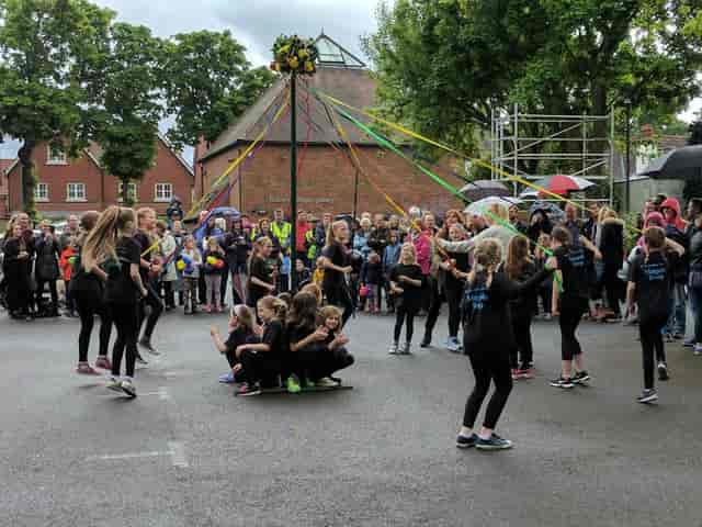 Maypole dance at Robert Phillips Gallery event in Riverhouse Barn, showcasing community engagement.