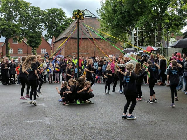 Maypole dance at Robert Phillips Gallery event in Riverhouse Barn, showcasing community engagement.