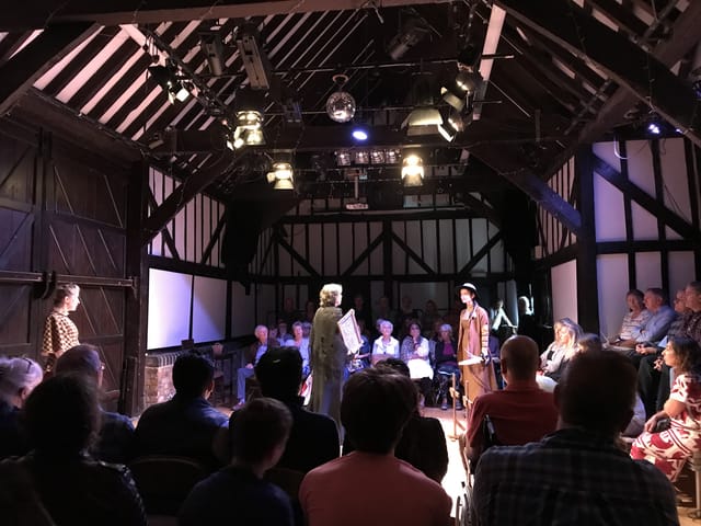 Intimate theater with wooden beams at Riverhouse Barn Arts Centre for engaging performances.