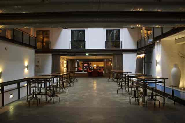 Versatile Denk.Mal Hall at Gastwerk Hotel Hamburg for events, featuring large windows.