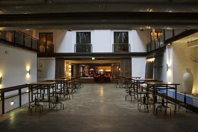 Versatile Denk.Mal Hall at Gastwerk Hotel Hamburg for events, featuring large windows.