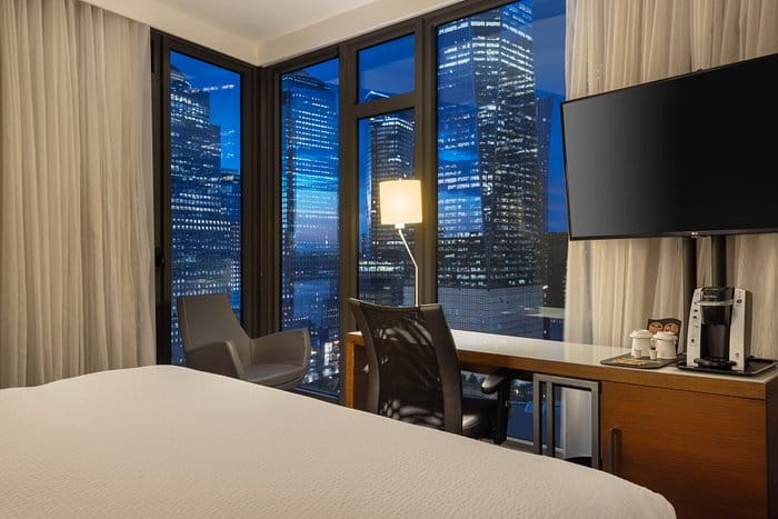 Modern hotel room with city skyline view perfect for business events and networking.