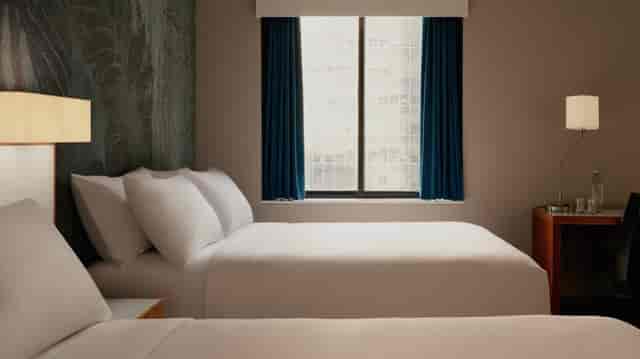 Single room at The Cloud One Hotels with two beds, ideal for event attendees.