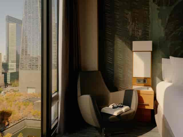 Modern hotel room with city view, ideal for conferences and meetings.