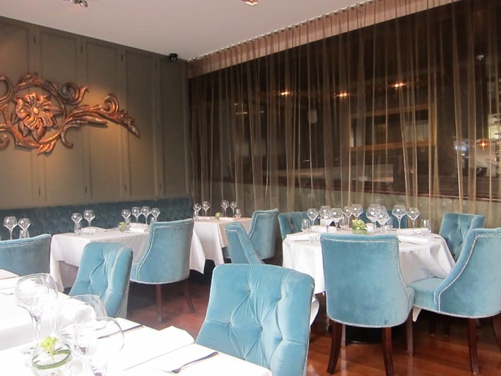 Elegant restaurant with plush chairs, ideal for intimate gatherings and corporate dinners.