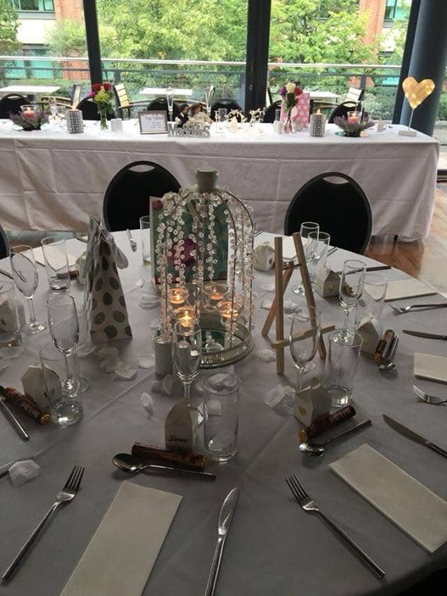 Elegant event table setting with decorative candle centerpiece in Greenhouse Function Room.
