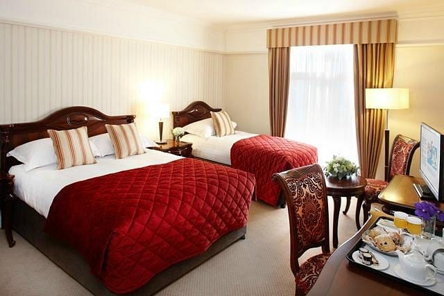 Elegant twin beds in Red Cow Moran Hotel conference room, ideal for events and networking.