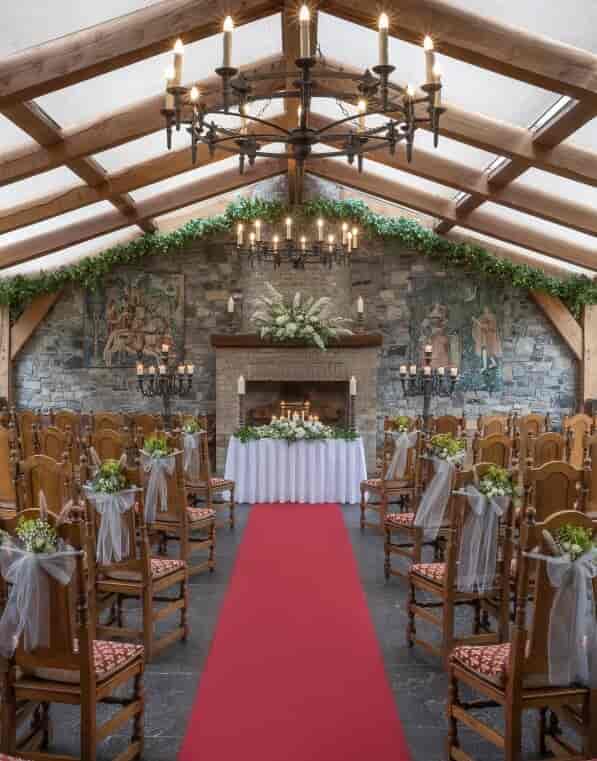 Medieval Hall in Barberstown Castle, elegant wedding venue with floral decor and candlelight.