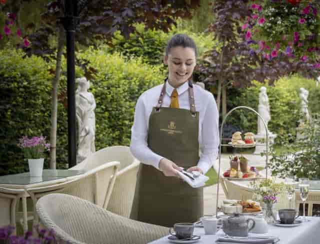 "Elegant restaurant staff at Barberstown Castle, inviting outdoor event setting"