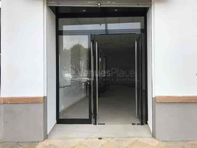 Modern entrance with double glass doors at Cotopaxi venue for events and meetings.