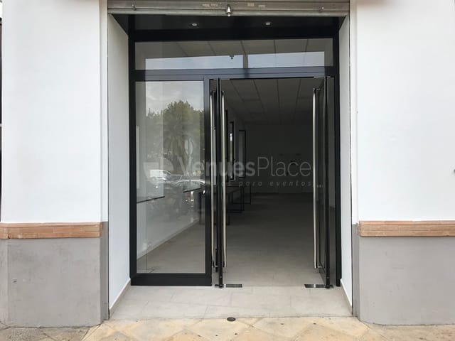 Modern entrance with double glass doors at Cotopaxi venue for events and meetings.