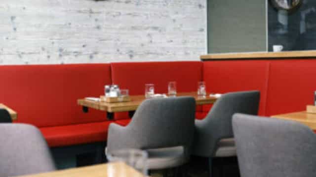 Cozy restaurant in Hummer Pedersen with vibrant red seating for small group meetings.