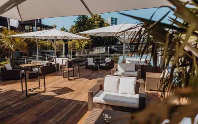 Stylish outdoor lounge with comfortable seating at KAI10 Floating Experience event venue.