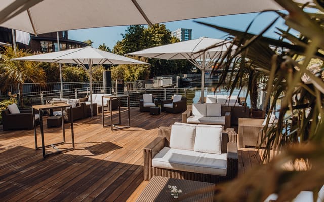 Stylish outdoor lounge with comfortable seating at KAI10 Floating Experience event venue.