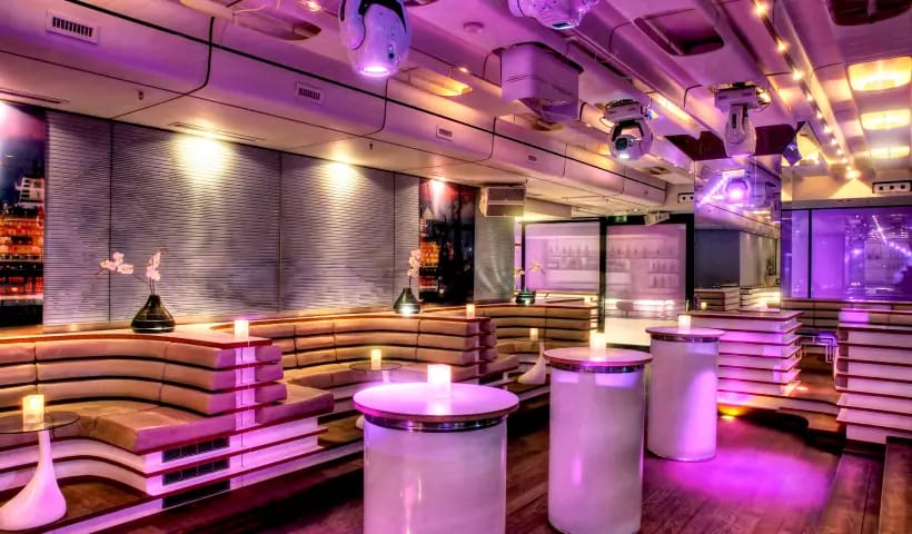 Modern event space with purple lighting, ideal for parties and receptions.