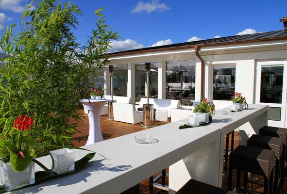 Chic outdoor lounge event, white furniture, heaters