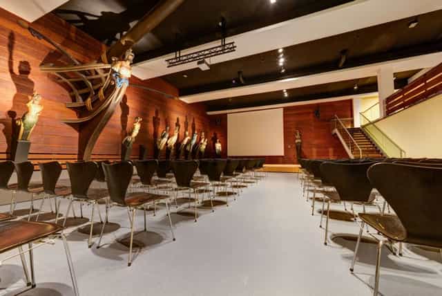 Museum gala venue, ornate backdrop, event presentation