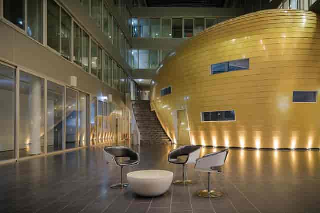 KLU Foyer: Golden pod, modern atrium, corporate event, branding