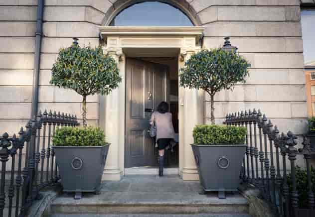 Eileen Gray entering elegant venue for upscale events at No. 25 Fitzwilliam Place.