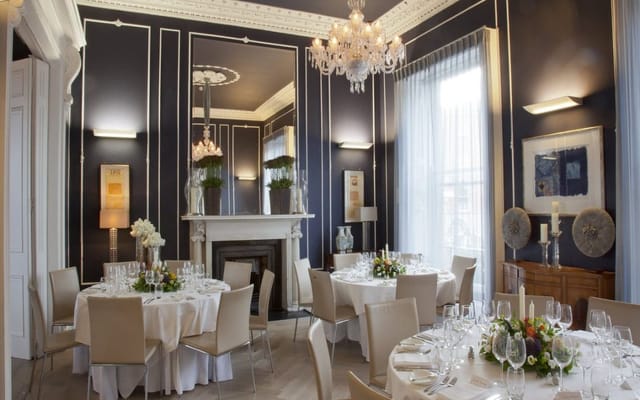 Eileen Gray's elegant dining space with chandelier, perfect for upscale events and gatherings.