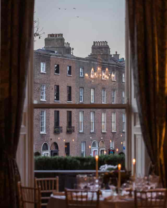 Fine dining restaurant window view, cozy chandeliers, intimate event space in Dublin.