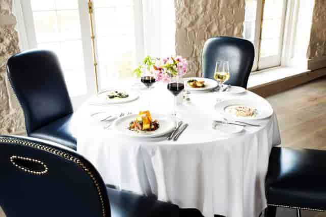 Elegant round table at The Mill Restaurant, perfect for upscale dining events.
