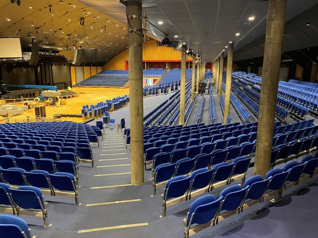 Conference auditorium with tiered seating, event venue