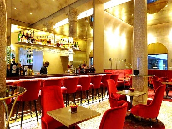 Milano hotel bar, plush red seating, cocktail reception, VIP lounge