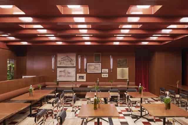Mid-century modern event space, warm wood, intimate dinner, reception, conference.