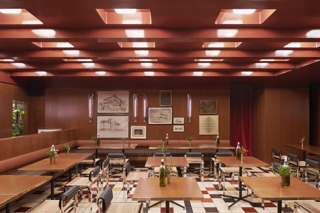 Mid-century modern event space, warm wood, intimate dinner, reception, conference.