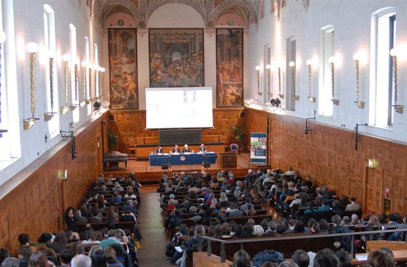 Milan Uni lecture hall: tiered seating, AV, historical charm. Academic conference, seminar.