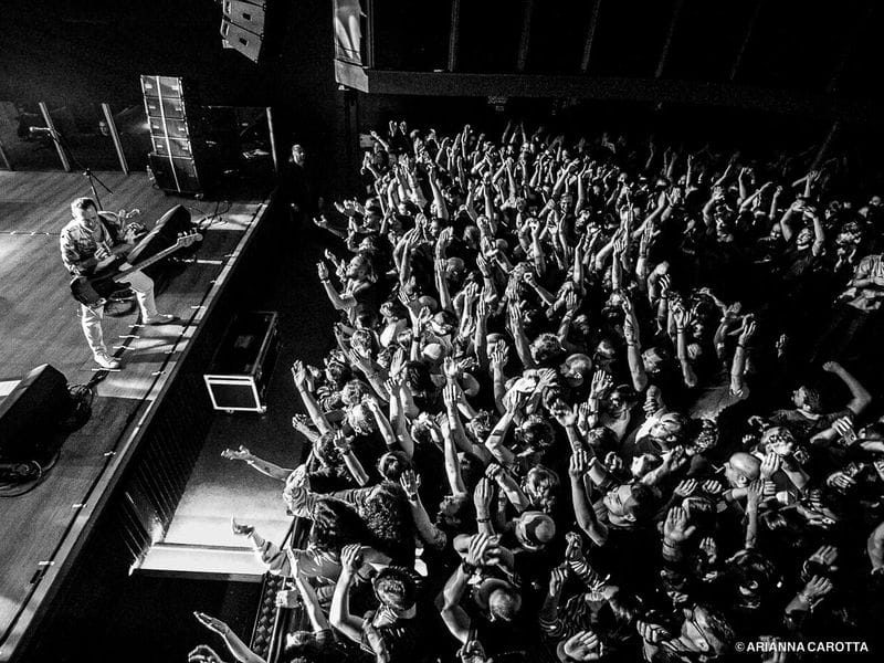 Sold-out concert stage, energetic crowd, live music event