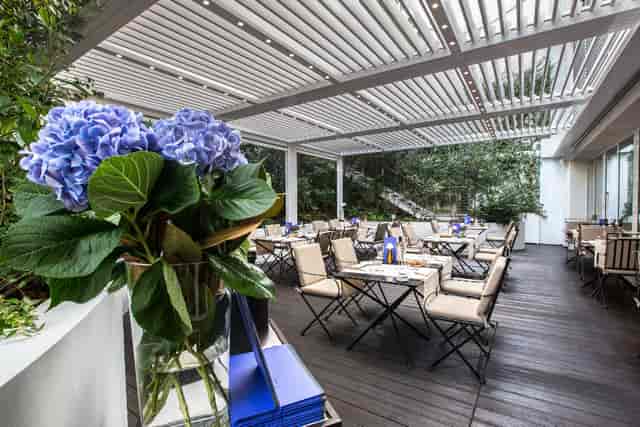 DA NOI IN Restaurant outdoor dining area with blue hydrangeas, ideal for events and gatherings.
