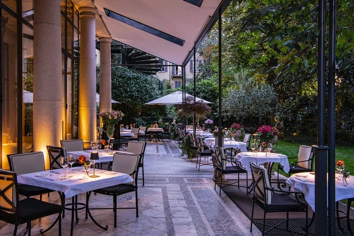 Charming outdoor dining area at Palazzo Parigi, perfect for intimate receptions and events.