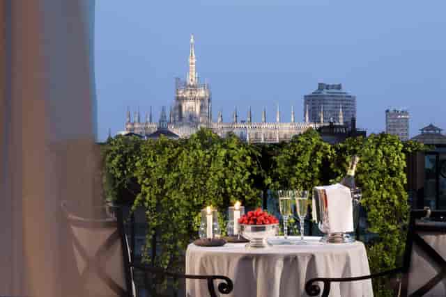 Elegant balcony dining for two at Palazzo Parigi, ideal for intimate events with stunning views.