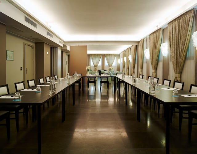 Fornasetti Meeting Room at Bianca Maria Palace Hotel, U-shaped table for corporate events.