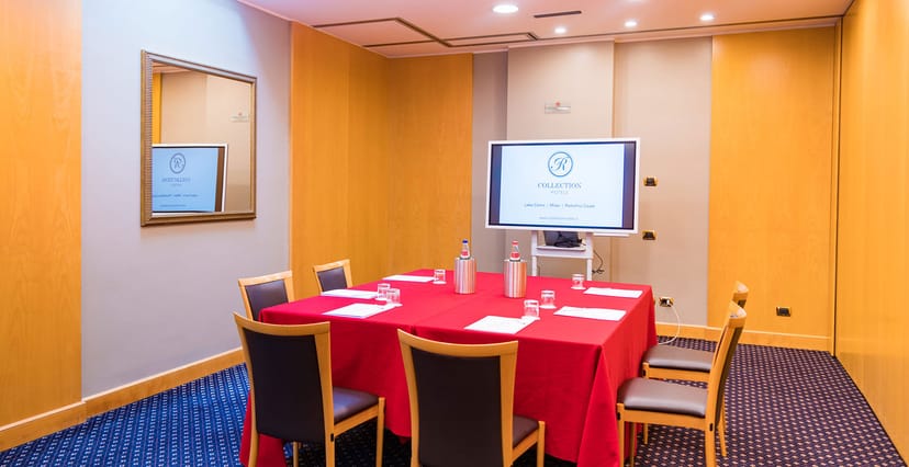 Regina Hotel meeting room, red tablecloth, presentation screen, business event