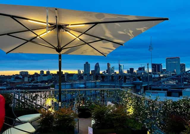 Rooftop venue at UNAHOTELS Galles Milano for evening receptions with city skyline views.