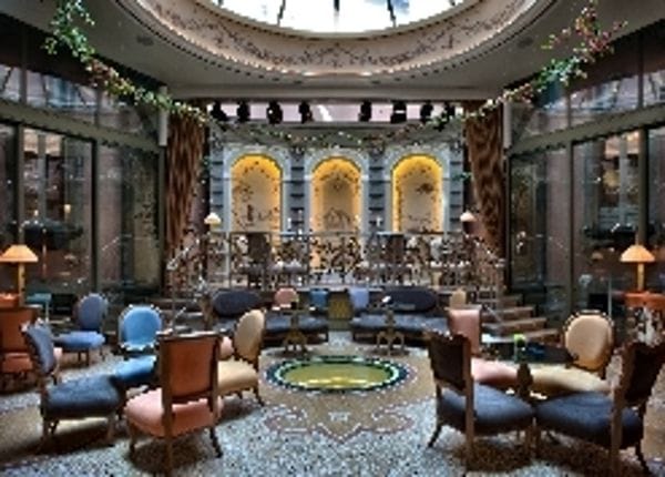 Milan hotel event space with atrium stage for corporate functions