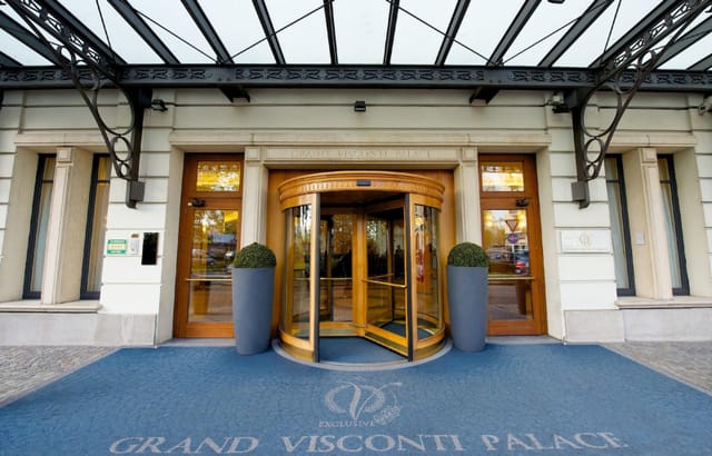 Elegant entrance of Grand Visconti Palace, featuring a stylish revolving door for corporate events.