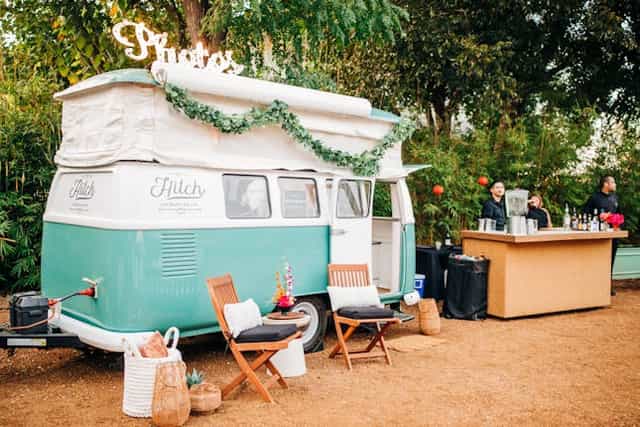 Vintage camper photo booth at event with bar
