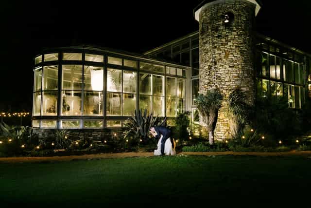 Rustic glass event venue, string lights, wedding gala