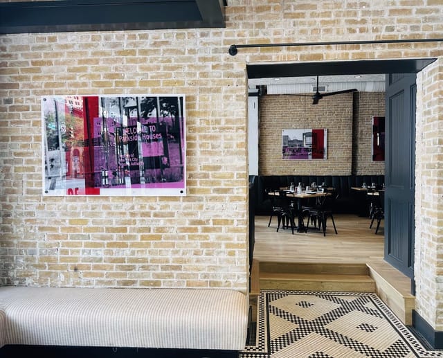Chic bistro venue, exposed brick, modern art. Event space, party venue.