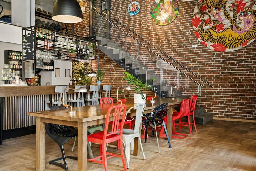 Industrial chic hotel event suite, communal table, networking event